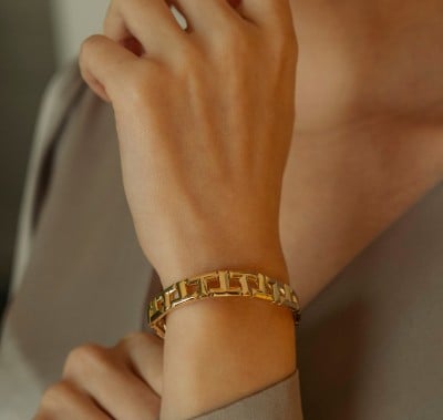 A pair of elegant hoop earrings adorned with sparkling diamonds at the top, showcasing a luxurious design.