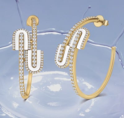 A woman elegantly displays two gold rings on her hand, showcasing their intricate design and shimmering beauty