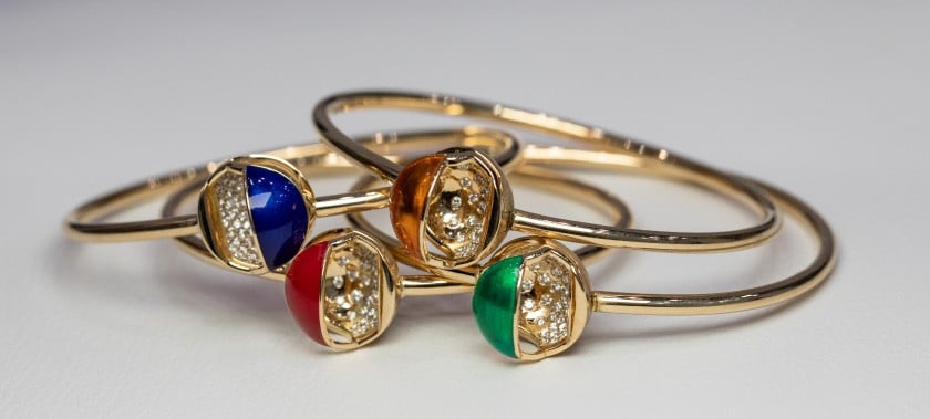 A trio of rings featuring colorful gemstones, each displaying a unique and eye-catching arrangement.