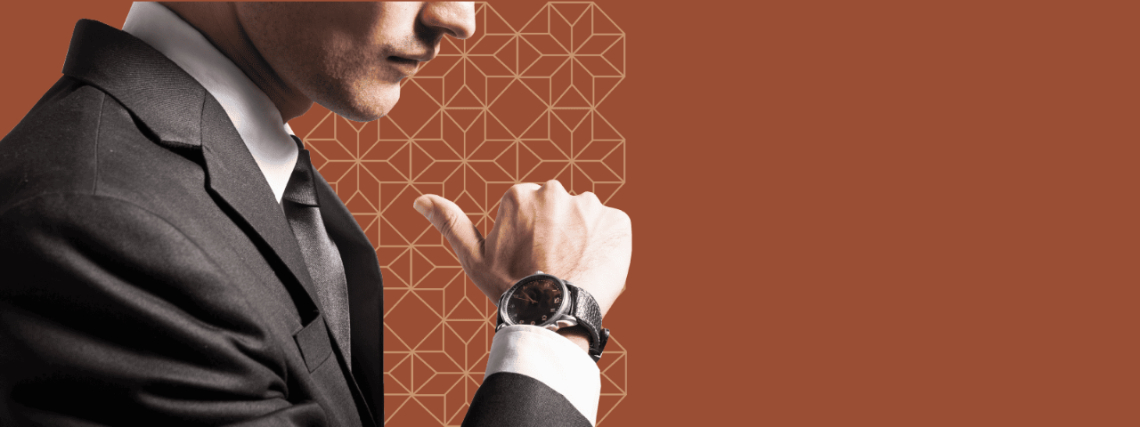 Young man in a gray suit, showcasing a nice watch