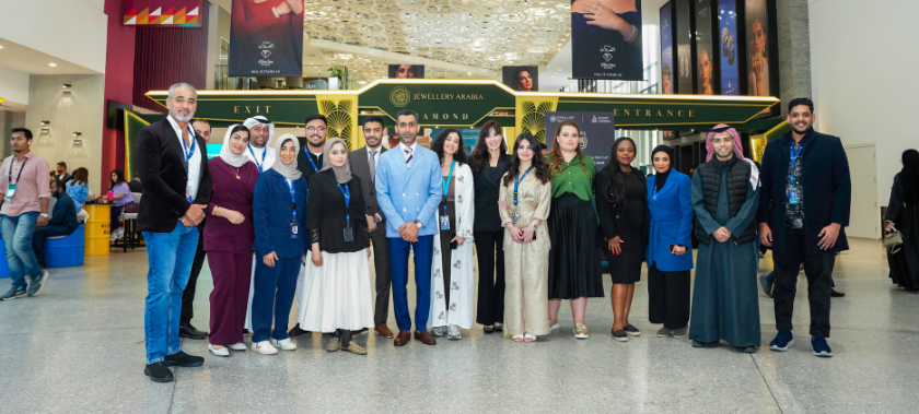 Group of Informa colleagues posing in front of the Jewellery Arabia entrance